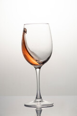 Splash of rose wine in glass, frozen motion