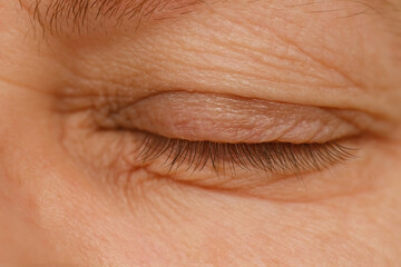 close up part face mature woman 55 years old, closed human eye, lower, upper eyelid, deep wrinkles...
