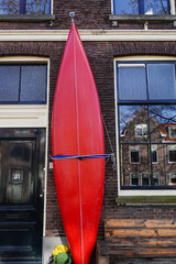 Delf, Netherlands A canoe is strapped to the facade of a house on a canal.