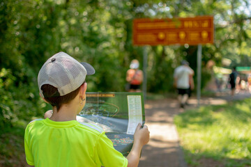 niño mirando mapa en sendero Iguazú