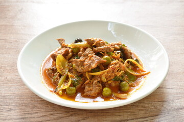 spicy fried barking deer meat with curry and eggplant on plate