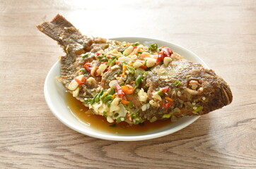 fried mango fish dressing spicy sauce herb sauce on plate 
