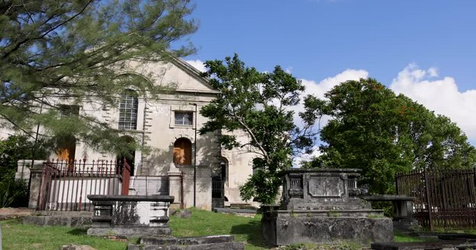 Somber weathered grave markers in cemetery at the Cathedral of St. John the Devine in the port town of St. John, Antigua