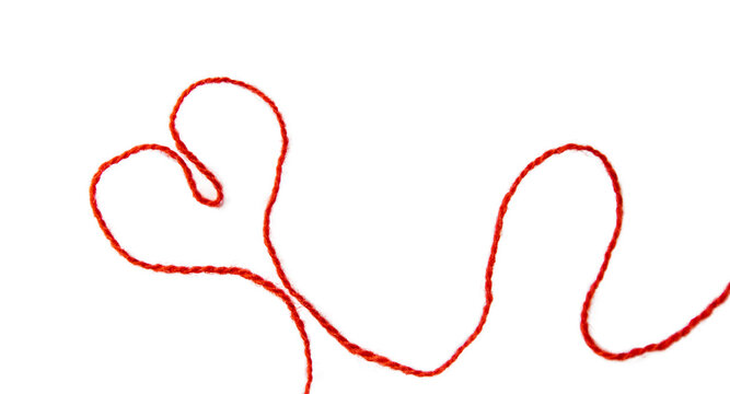 Red thread isolate on white background. Selective focus. Old.