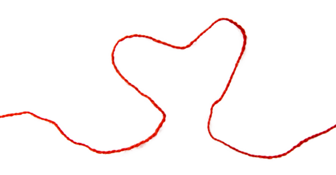 Red thread isolate on white background. Selective focus. Old.