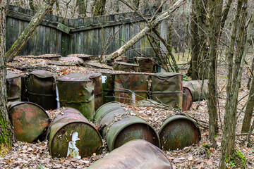 Rusty fuel barrels near the abandoned warehouse at Chernobyl exclusion zone