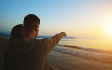 Couple at sunset by the sea.