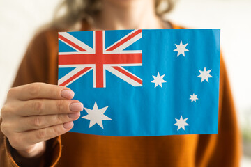 hand holding Australian flag, isolated on white background