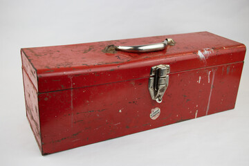Old red retro handyman toolbox on white background