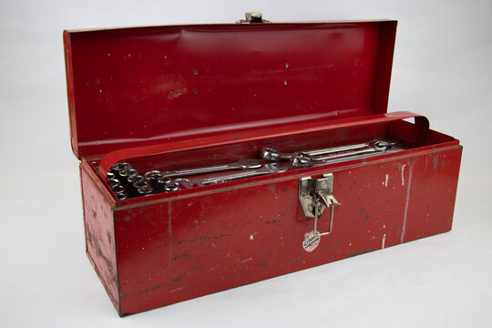 Old red retro handyman toolbox on white background
