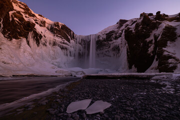 Great long exposure of a huge waterfall called Skogafoss in Iceland at a great sunrise.