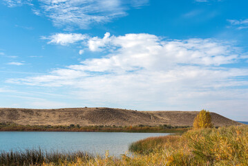 Low horizon peaceful background photograph of a recreational lake in the high desert in western Colorado