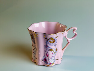 Porcelain pink cup of an unusual shape is made in the Czech Republic. A cup with a romantic pattern...
