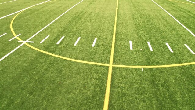 Sport games field grass view. Football field with green grass and white paint lines and marks. Sports soccer and football with nice green environment. Recreational activity ground.