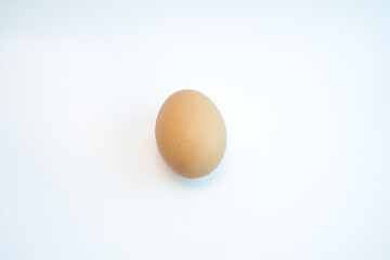 Single brown chicken egg isolated on white background. Food and cooking ingredient concept. 