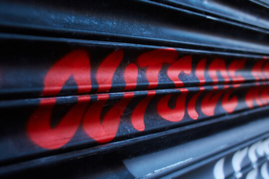 Dublin, Ireland - 01.27.2023: Beautiful inscription "outside"on wall. Abstract text of spray painted. Urban style