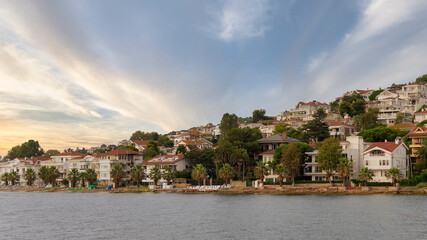 Fototapeta na wymiar View of the hills of Kinaliada island from Marmara Sea, with traditional summer houses at dawn, Istanbul, Turkey
