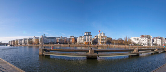 Obraz premium Panorama, Piers and waterfront apartment houses at the canal Danvikskanalen in the bay Hammarby sjö a sunny winter day in Stockholm
