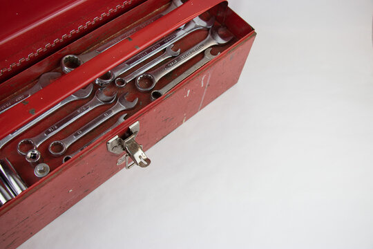 Old red retro handyman toolbox on white background