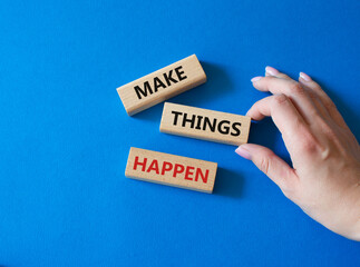 Make things happen symbol. Concept word Make things happen on wooden blocks. Businessman hand. Beautiful blue background. Business and Make things happen concept. Copy space