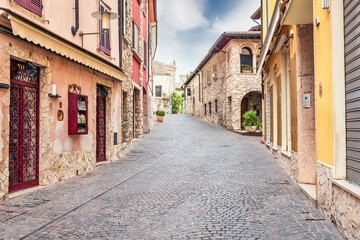 Fototapeta na wymiar Town of Sirmione, Lake Garda, colorful street view. Tourist destination in Lombardy region of Italy