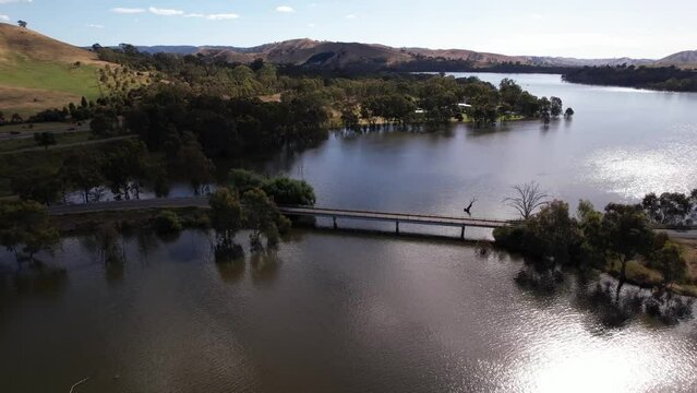 Circling aerial small bridge over lake Eildon, Victoria Australia