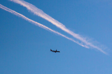 Aircraft contrails in the blue sky.Airplane in the sky.