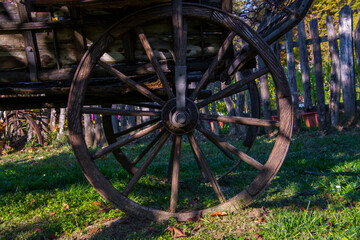 Fototapeta na wymiar Wooden wheel of chariot on a sunny day