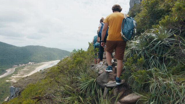 Family hiking in the tropical forest. Extended family with kids explore the jungle trails and walk in the tropical forest