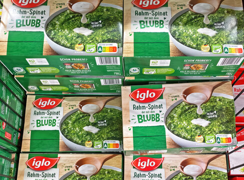 Viersen, Germany - January 9. 2023: Closeup of packs frozen Iglo spinach in cooling counter