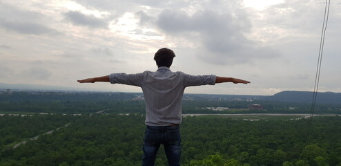 Panoramic view of Dehradun city from dwara hills, A Person enjoying landscape view from roadside