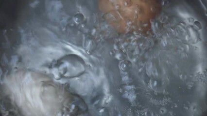 Chicken eggs are boiled in boiling water.