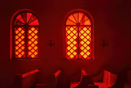 Vintage stained glass window in red wall in church. Interior design concept.