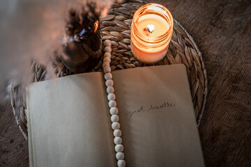 Journal mock-up with pampas grass, candle, wooden beads