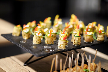 light snacks for the holiday, catering. Various light snacks. Catering plate. Assortment of sandwiches on the buffet table. meat, fish, vegetable canapes.