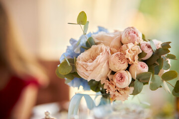 the wedding bouquet is on the table. Wedding. The bride's bouquet. Bridal bouquet. Pink wedding bouquet stands on the table