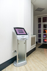 A modern touch screen terminal for customer service, an electronic queue in the service sector. Using a self-service kiosk or a terminal with a screen. A quick way to order food and buy tickets.