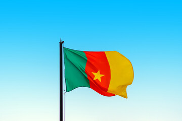 Flag of the Republic of Cameroon against the bright blue sky