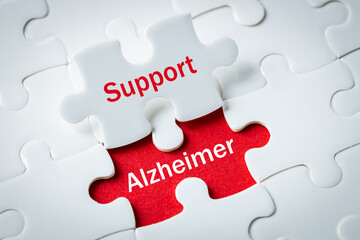 Fototapeta premium alzheimer's disease, Puzzle with exposed words Support and alzheimer, Concept, Help and support for elderly people struggling with progressive neurodegenerative disease