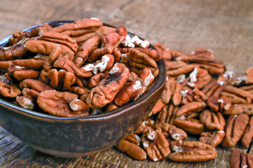 Bowl with pecan on rustic wooden table
