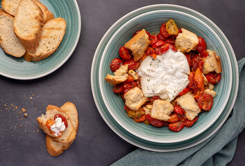 Food photography of baked tomatoes, cheese, burrata, mozzarella, garlic, crouton, thyme, toast