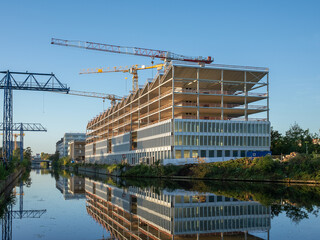 Construction site of a modern office building by a river 