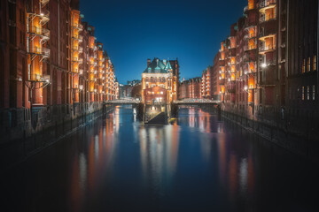 Fototapeta premium Famous view of Speicherstadt warehouse district with Wasserschloss Building at night - Hamburg, Germany