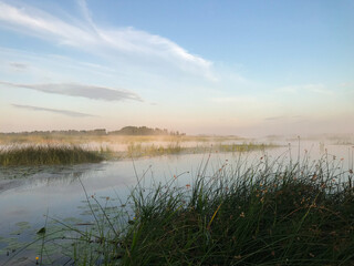 Summer, foggy landscape on the lake with blue sky with reflection of clouds in the lake. tourism and travel concept. high quality photo