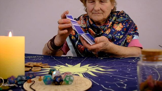 Fortune teller woman reads tarot cards. Selective focus.