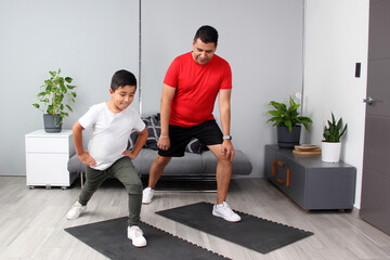 Fototapeta premium Overweight Latino dad and son exercise at home to lose weight and be healthy to avoid diseases such as diabetes or hypertension