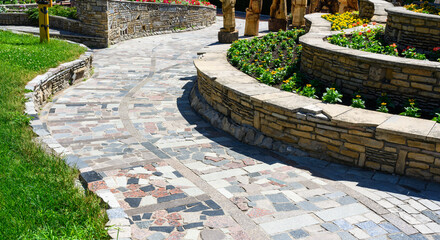 Landscape design of home garden, tiled walkway and stone retaining walls