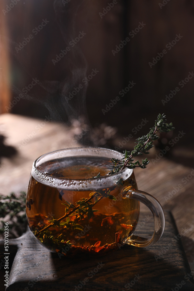 Wall mural tea with thyme in a transparent mug