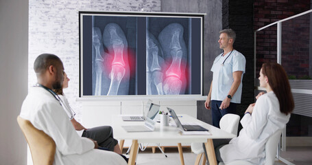 Doctors And Radiologists Discussing X-ray Images