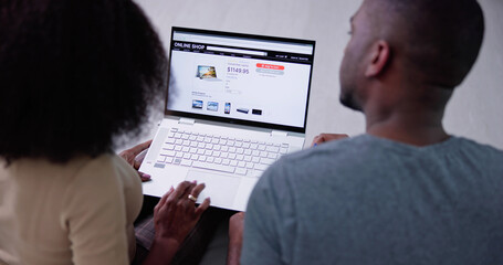 Obraz na płótnie Canvas Young Couple Shopping Online On Laptop